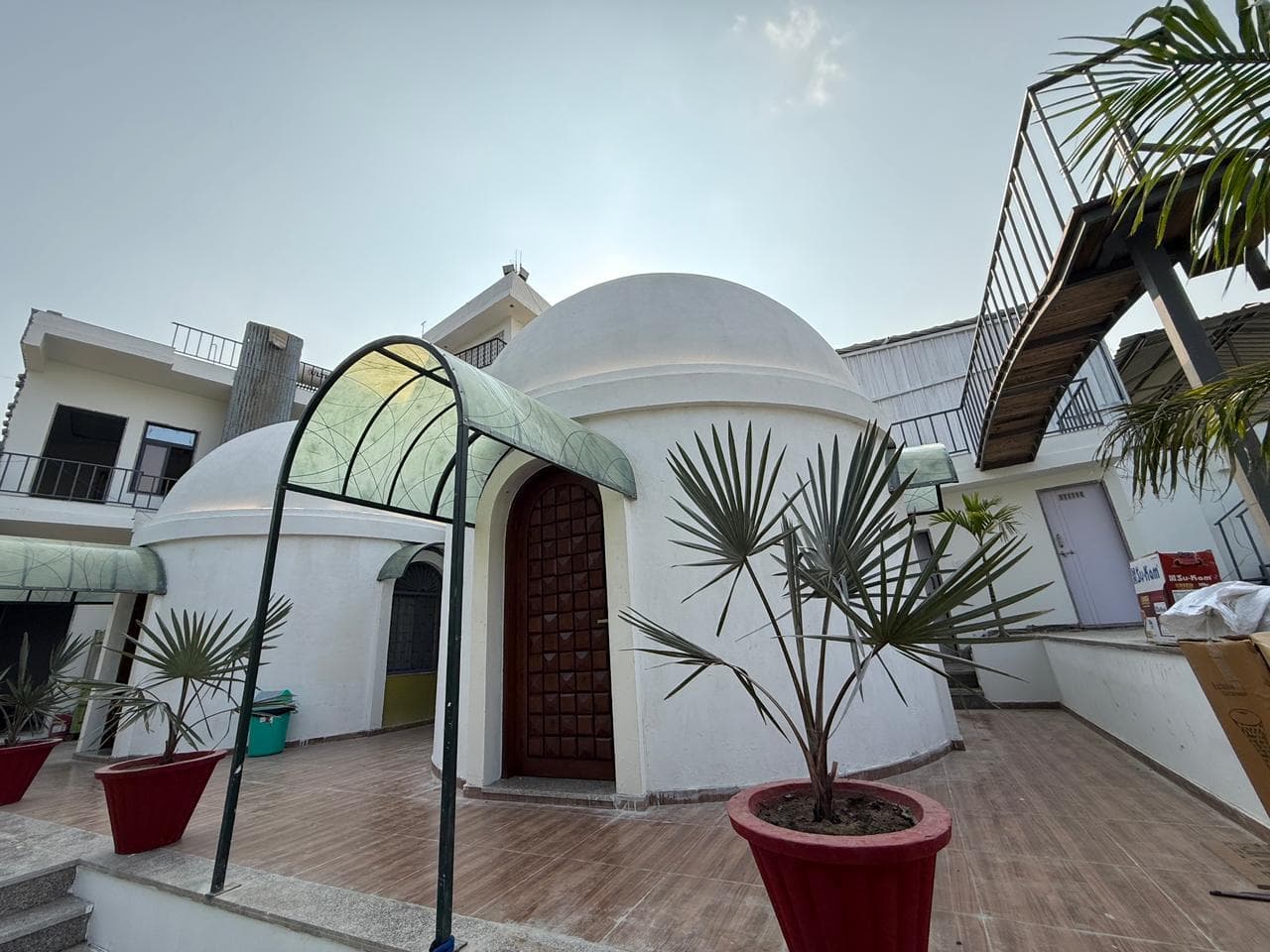 Dome cottage with swimming pool visible in background