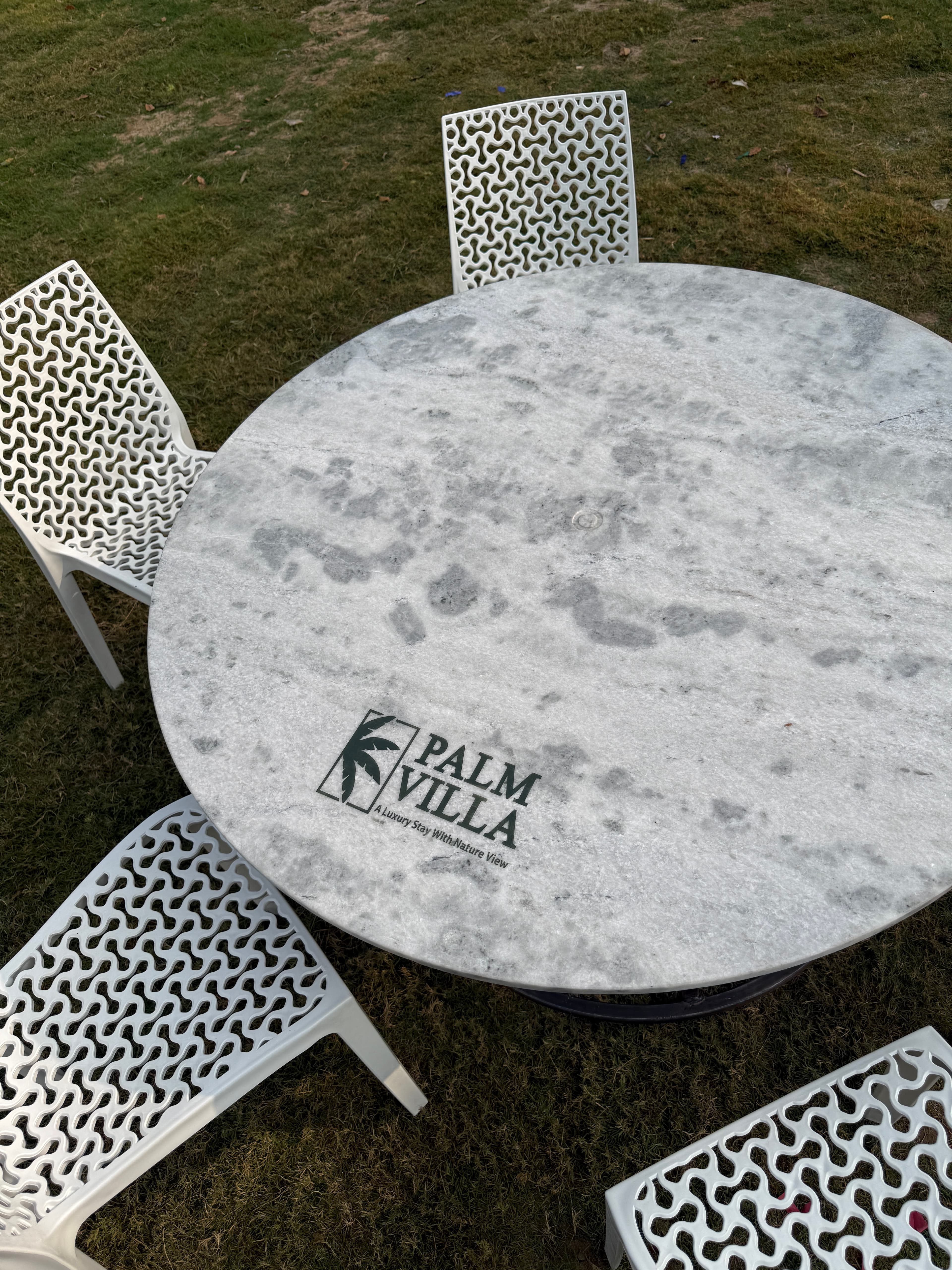 Palm Villa branded garden table top-down view