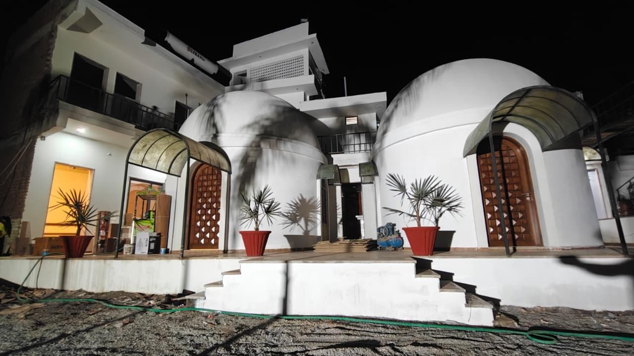 Dome cottages illuminated at night with arch canopies