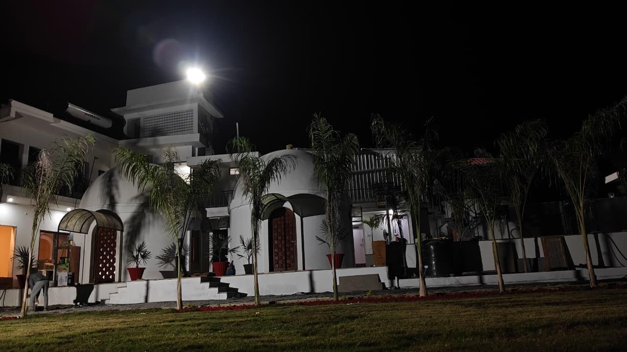 Palm Villa full property view at night with bright lighting