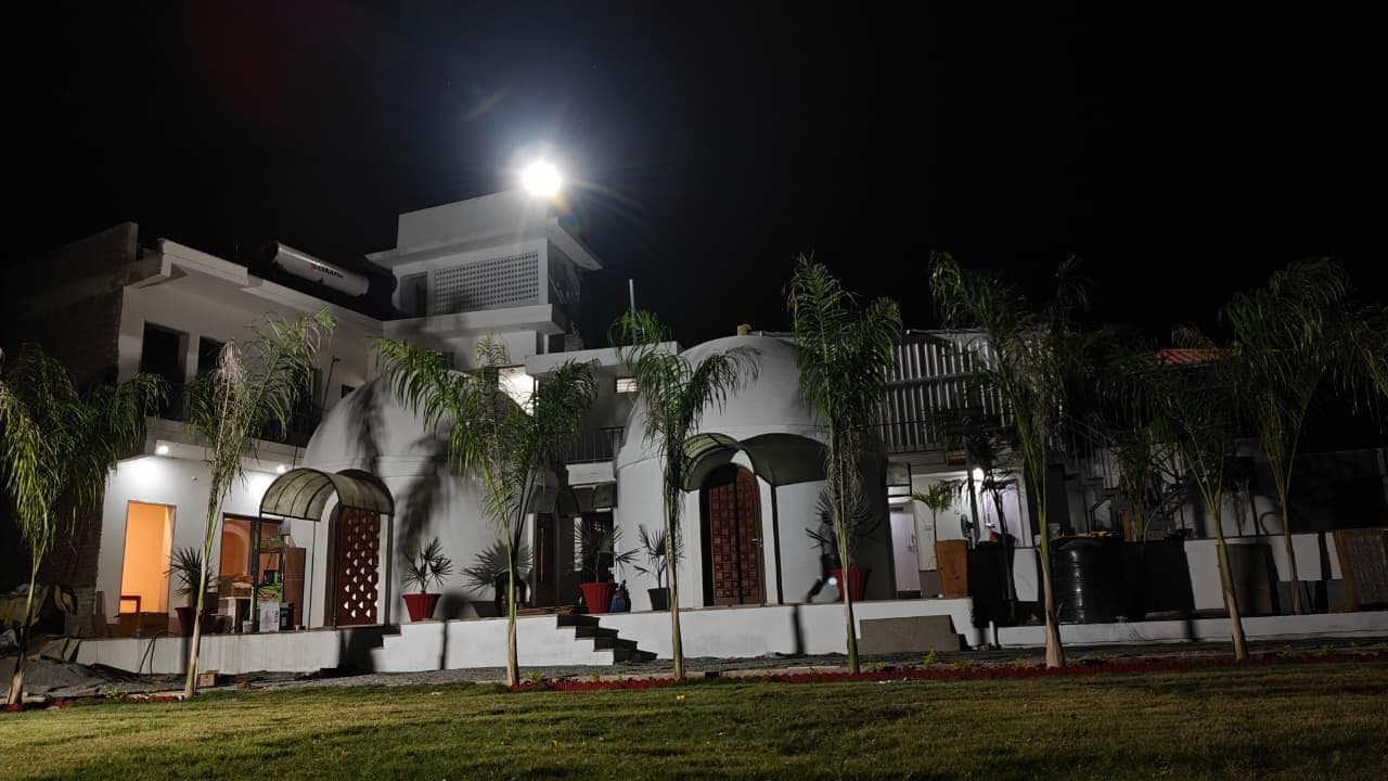 Full property view at night with lawn