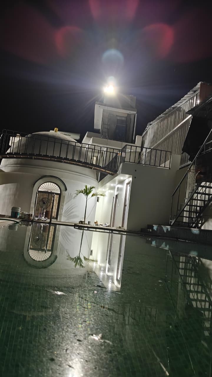 Swimming pool at night reflecting dome building